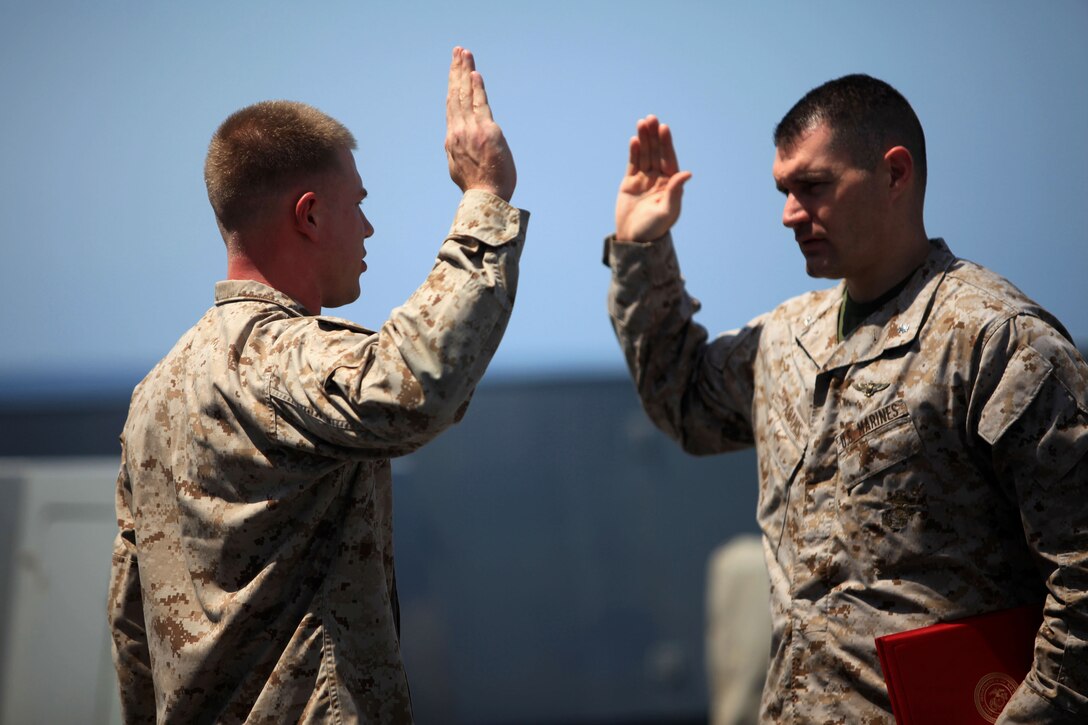 Lt. Col. Aaron W. Adams, right, 24th Marine Expeditionary Unit executive officer, administers the oath of office to Gunnery Sgt. Derek Brossman during his promotion ceremony aboard the USS New York, Oct. 1, 2012. The 24th MEU is deployed with the Iwo Jima Amphibious Ready Group as a theater reserve and crisis response force for U.S. Central Command in the U.S. Navy's 5th Fleet area of responsibility. (Official Marine Corps photo by 2nd Lt. Joshua W. Larson)