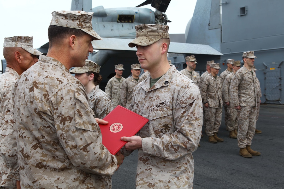 Sgt. Michael Cox, a Brighton Ill., native with the Command Element, 24th Marine Expeditionary Unit, is promoted to his current rank of Sergeant in the US Marine Corps by Col. Frank Donovan, commanding officer of the 24th MEU during a ceremony aboard the USS Iwo Jima (LHD 7), Oct 1, 2012.  The 24th MEU is deployed with the Iwo Jima Amphibious Ready Group as a theater reserve force for U.S. Central Command and is providing support for maritime security operations and theater security cooperation efforts in the U.S. Navy's 5th Fleet area of responsibility. (U.S. Marine Corps photo by Gunnery Sgt. Chad R. Kiehl)