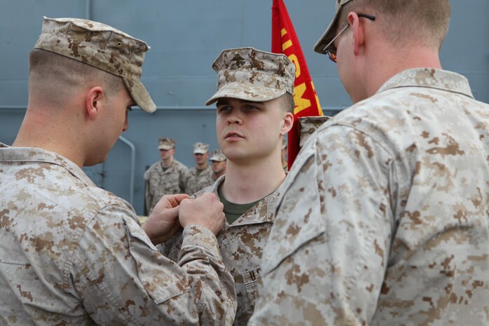 Cpl. Kyle Taylor, a Hearns  Texas, native with the Command Element, 24th Marine Expeditionary Unit, is promoted to his current rank of Corporal in the US Marine Corps during a ceremony aboard the USS Iwo Jima (LHD 7), Oct 1, 2012.  The 24th MEU is deployed with the Iwo Jima Amphibious Ready Group as a theater reserve force for U.S. Central Command and is providing support for maritime security operations and theater security cooperation efforts in the U.S. Navy's 5th Fleet area of responsibility. (U.S. Marine Corps photo by Gunnery Sgt. Chad R. Kiehl)