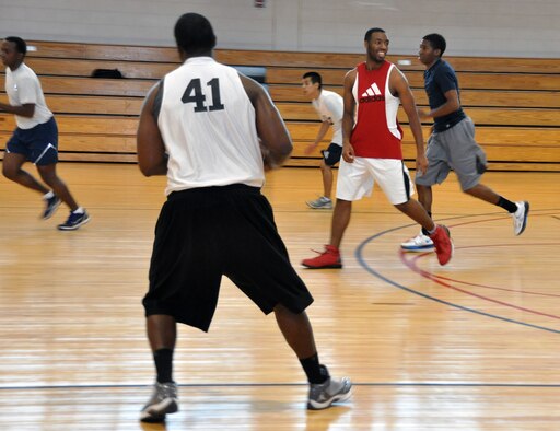 Service members from Osan Air Base and U.S. Army Garrison Yongsan participate in a basketball tournament during the 2012 Sports Day event held at Osan, Sept. 28, 2012. Participants from Kunsan and Daegu air bases traveled to Osan to compete in a day full of sporting events that included football, softball, dodge ball, volleyball and bowling. (U.S. Air Force photo/Senior Airman Michael Battles)