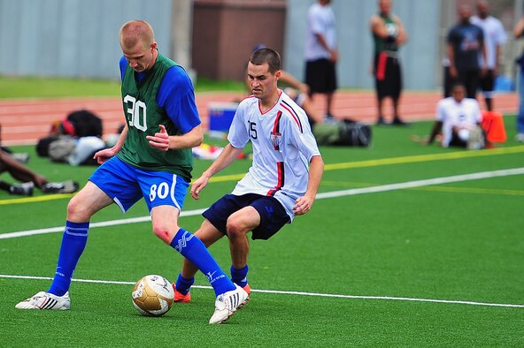 Senior Airman Joshua McMaster maneuvers a ball up-field in a soccer tournament as Specialist Travis Gilley plays tight defense during the 2012 Sports Day event held at Osan Air Base, Sept. 28, 2012. Yongsan took third in the day’s events by winning the dodge ball portion of the competition. Kunsan ranked second after winning in basketball, but Osan won overall in softball, football, soccer, bowling and volleyball. McMaster is a client systems technician with the 8th Communications Squadron and Gilley is a U.S. Army Soldier with the 142nd Military Police. (U.S. Air Force photo/Staff Sgt. Craig Cisek) 