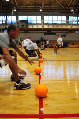 Service members from Osan and Kunsan Air Base play dodge ball at the Osan fitness center during the 2012 Sports Day events, Sept. 28, 2012. Sports day provided an opportunity for Airmen and Soldiers from various squadrons to come together and enjoy a day of friendly competition. (U.S. Air Force photo/Tech Sgt. Raymond Mills)