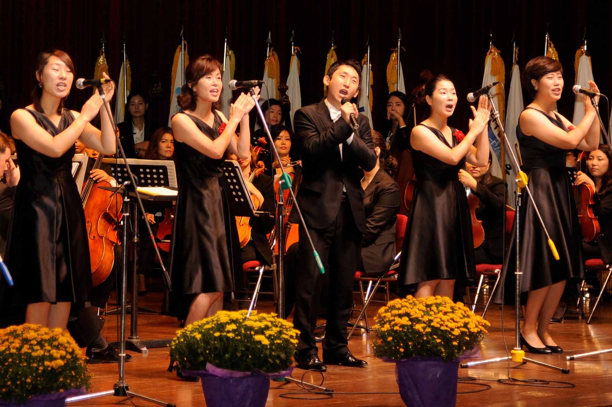 A full orchestra and musical team perform during the Gunsan City Citizens Appreciation Day at Gunsan City, Republic of Korea, Oct. 5, 2012. More than 32 individuals received awards for their dedicated service to their cities and community. (U.S. Air Force photo/Senior Airman Marcus Morris)