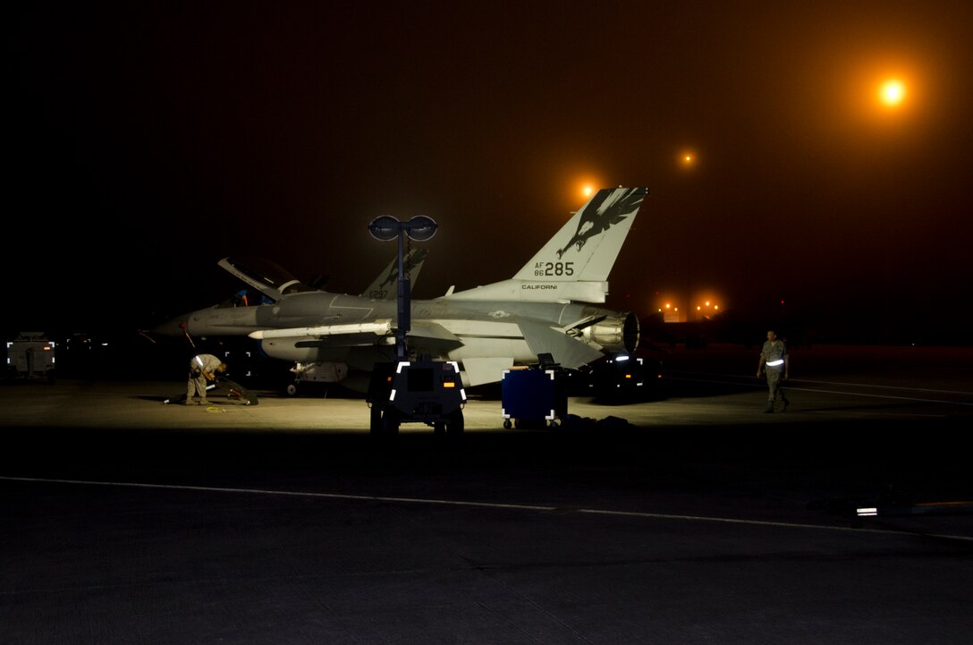 Airmen from the 144th Fighter Wing prep an F-16C Fighting Falcon's for an early morning training mission during Combat Archer, a weapon systems academics exercise, at Tyndall AFB, Florida, October 9, 2012.( Air National Guard photo by Tech. Sgt. Charles Vaughn)