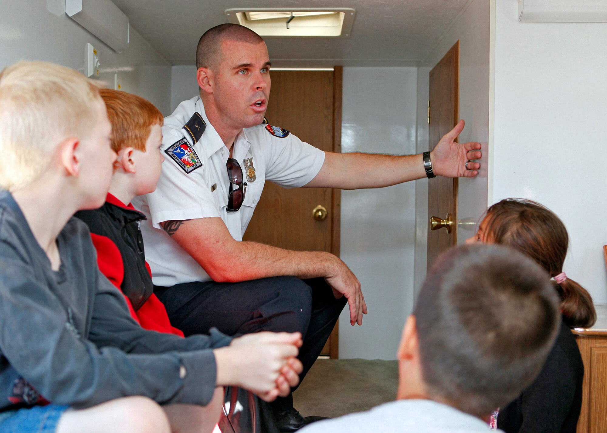 Phillip Remley, Edwards Fire inspector, trains Branch Elementary School students how to detect a fire in another room during Fire Prevention Week at Edwards Air Force Base, Calif., on Oct. 9, 2012. Fire Prevention Week was established to commemorate the Great Chicago Fire in 1871 that killed more than 250 people, left 100,000 homeless, destroyed more than 17,400 structures and burned more than 2,000 acres. (U.S. Air Force photo by Jet Fabara)