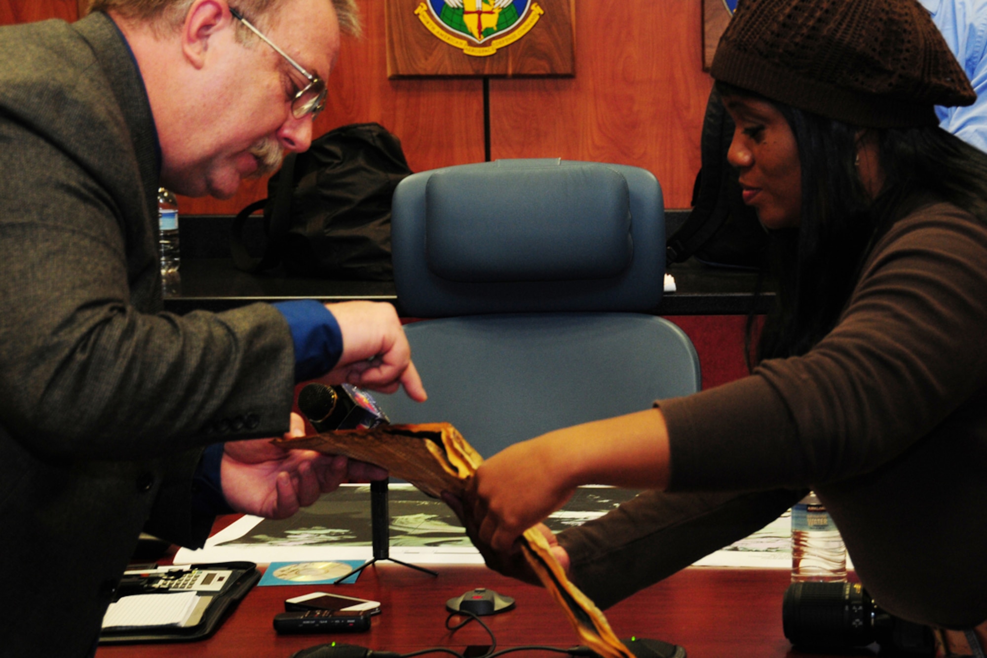 JOINT BASE ELMENDORF-RICHARDSON, Alaska -- Douglas Beckstead, 673rd Air Base Wing History Office, shows a navigation chart to Tonja Anderson during her visit here Sept. 28, 2012.  Anderson was in Alaska to learn about the 1952 C-124 crash that claimed the life of her grandfather and 51 other passengers. The aircraft wreckage was recently discovered on Colony Glacier, 14 miles south of the original crash site on Mt. Gannett.  During her visit, Anderson was able to view items recovered from the site.  (U.S. Air Force photo/Master Sgt. Mikal Canfield)