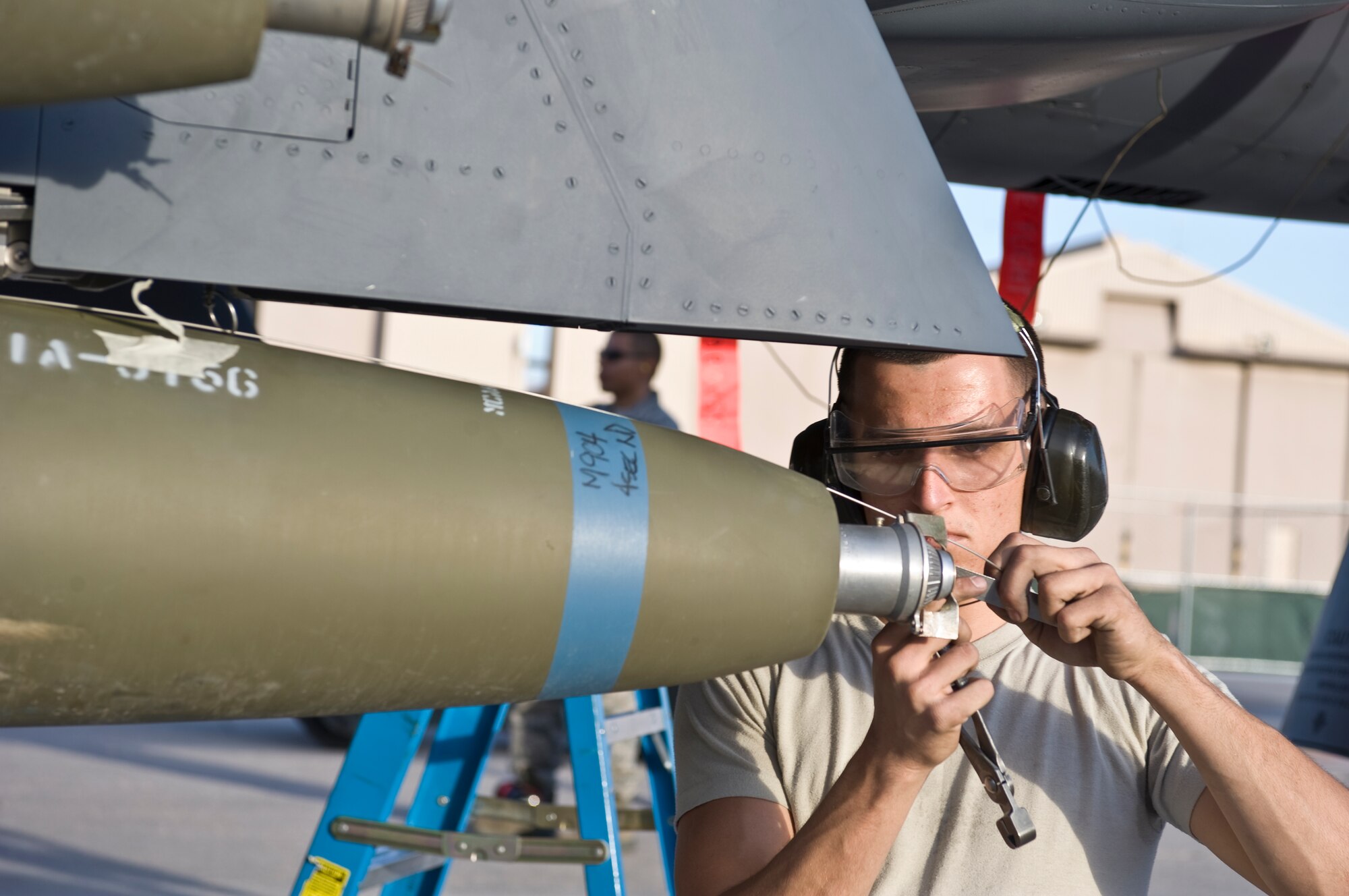 U.S. Air Force Senior Airman Earl Condra, 757th Aircraft Maintenance Squadron Strike Aircraft Maintenance Unit load crew member, loads a Mk-82 bomb onto an F-15E Strike Eagle during a quarterly load crew competition, Oct. 5, 2012, at Nellis Air Force Base, Nev. Weapons load competitions are conducted quarterly to keep Airmen sharp and recognize superior performers. (U.S. Air Force photo by Airman 1st Class Matthew Lancaster)
