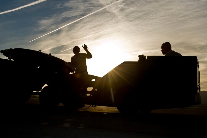 U.S. Air Force Airmen from the 57th Aircraft Maintenance Squadron participate in a quarterly load crew competition Oct. 5, 2012, at Nellis Air Force Base, Nev. The members of the winning unit receive three days off designated by the 57th Wing Commander, a traveling trophy, and bragging rights until the next competition. (U.S. Air Force photo by Senior Airman Daniel Hughes) 