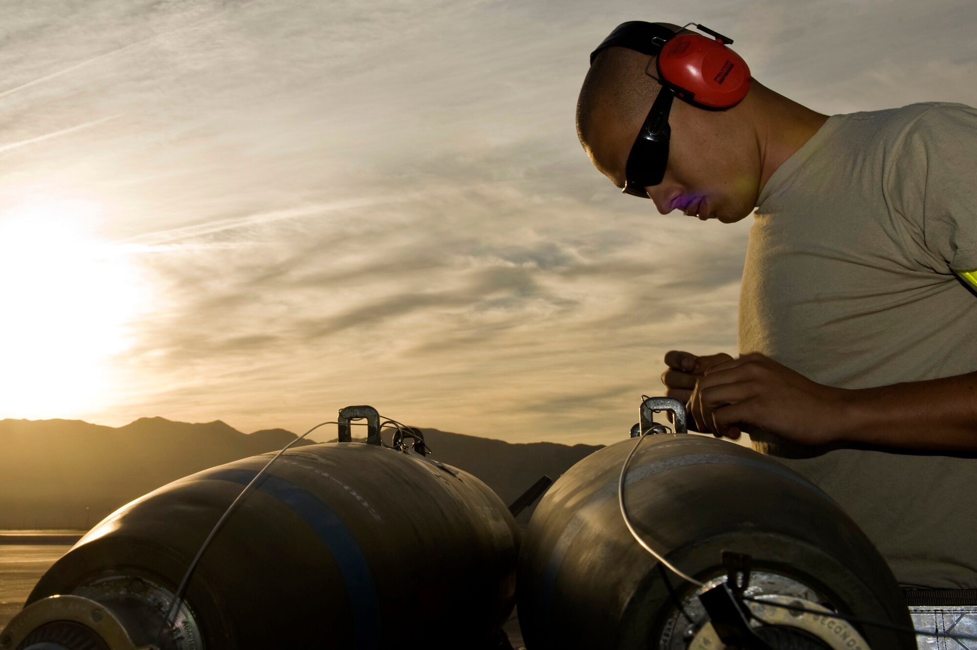 U.S. Air Force Senior Airman Jonathan Gonzalez, 57th Aircraft Maintenance Squadron weapons load crew member, checks the arming wire on a Mk-82 general purpose bomb during a load crew competition Oct. 5, 2012, at Nellis Air Force Base, Nev. During the event teams can bring their families and friends to watch and cheer. (U.S. Air Force photo by Senior Airman Daniel Hughes)
