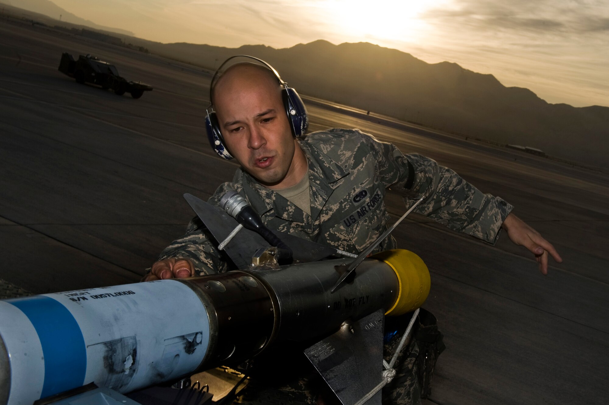 U.S. Air Force Senior Airman David Murray, 57th Aircraft Maintenance Squadron weapons load crew member, prepares an AIM-9 missile system before loading it to an F-16 Fighting Falcon during a load crew competition Oct. 5, 2012, at Nellis Air Force Base, Nev.  The quarterly weapons load crew competition tests the skills of Airmen from Viper,Thunder, Raptor, Falcon, Eagle,Tomahawk and Strike Aircraft Maintenance Units. The teams are judged on speed, accuracy and safety by section chiefs. (U.S. Air Force photo by Senior Airman Daniel Hughes)
