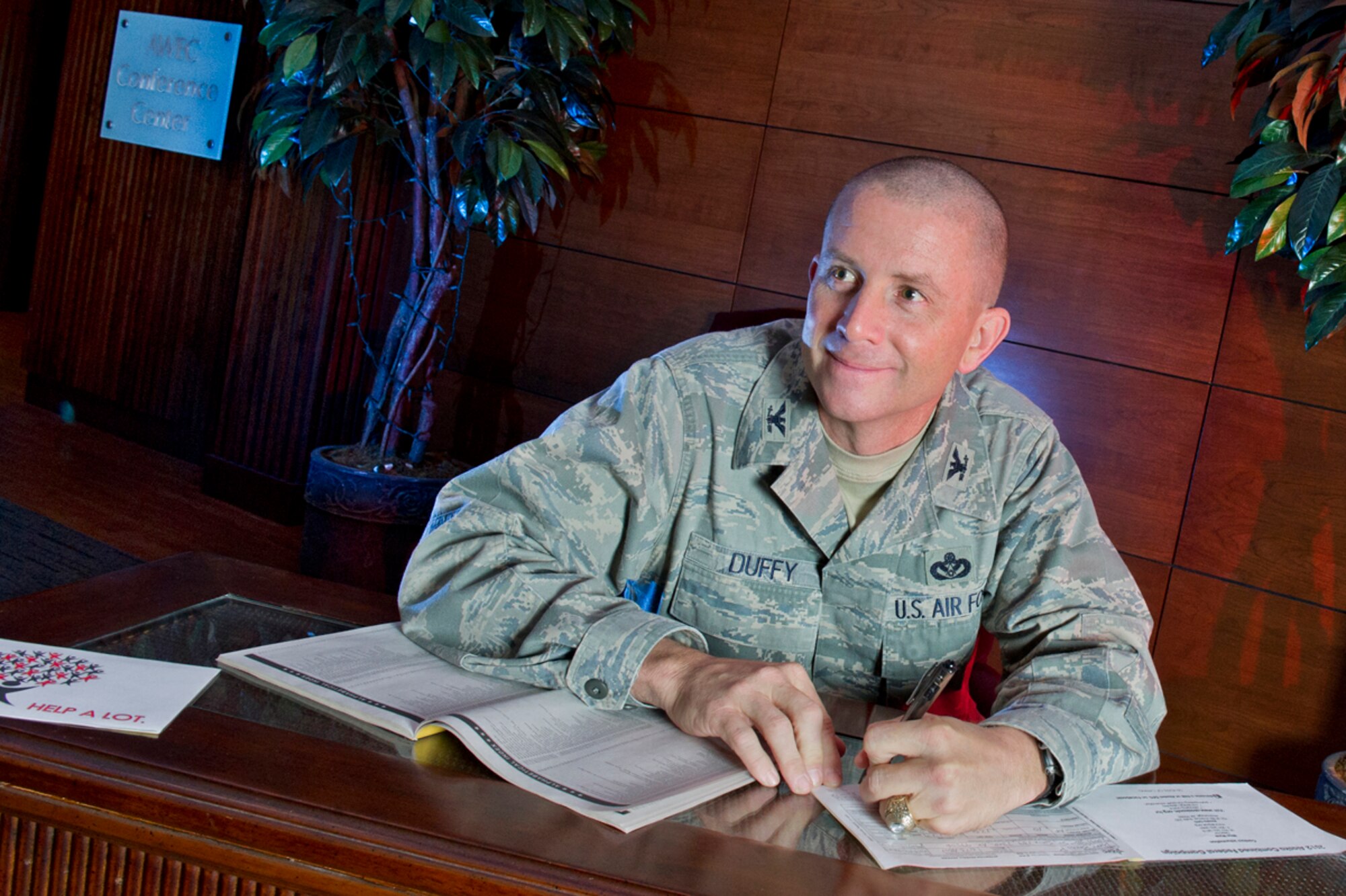 JOINT BASE ELMENDORF-RICHARDSON, Alaska -- U.S. Air Force Col. Brian P. Duffy, the commander of Joint Base Elmendorf-Richardson (JBER) and the 673d Air Base Wing, signs his personal contribution to the Combined Federal Campaign (CFC) at the Arctic Warrior Events Center, Wednesday, Oct. 3, 2012.  Combined Federal Campaign is the world's largest and most successful annual workplace charity campaign, with more than 200 CFC campaigns throughout the country and internationally to help to raise millions of dollars each year.  (U.S. Air Force photo by Justin Connaher)