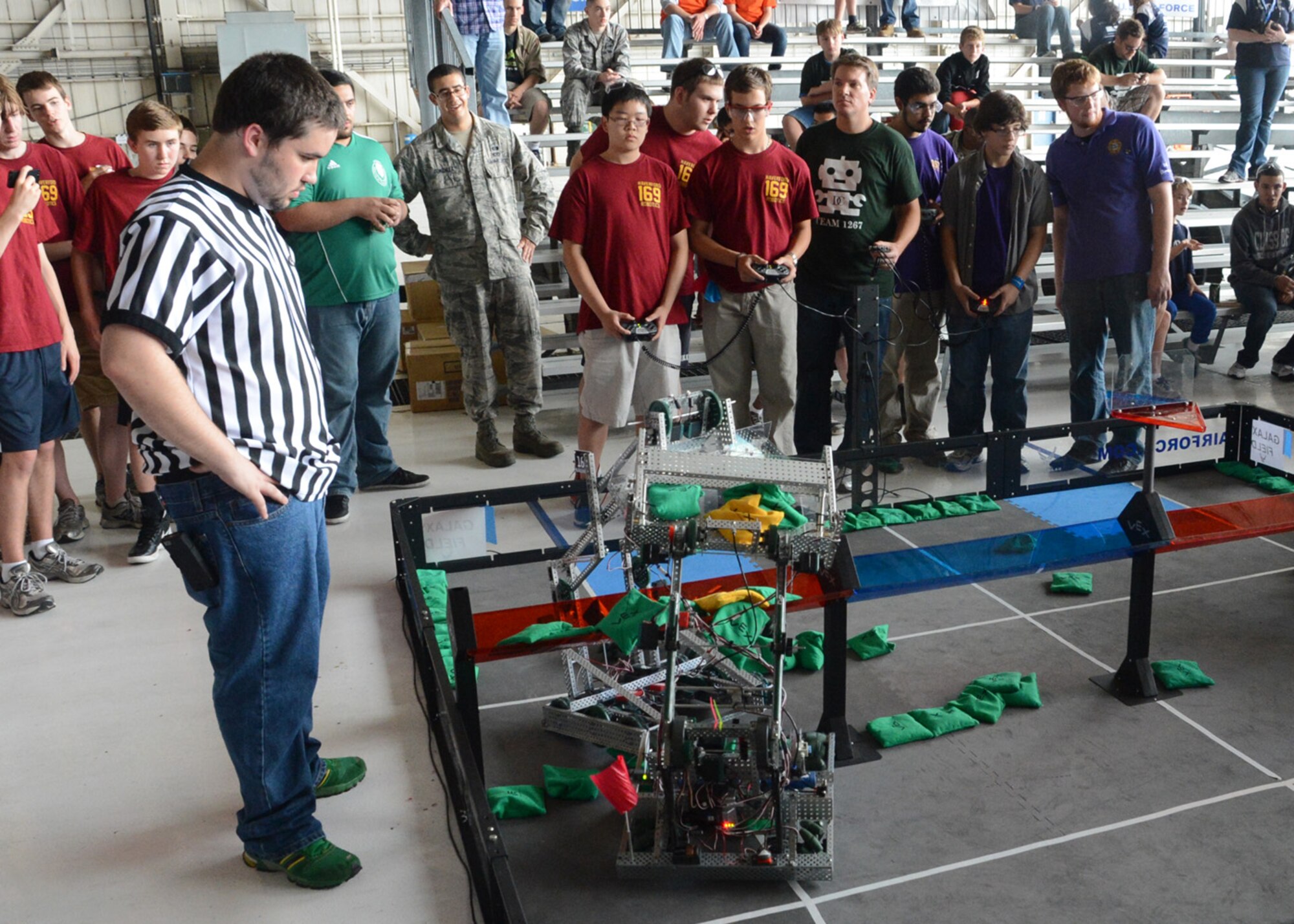 A referee looks on as competitors try to get their robots to score points during the semifinals of the Delaware State VEX Championship Oct. 6, 2012, at Hangar 706 on Dover Air Force Base, Del. Team Dover was the first-ever military installation to host the VEX robotics competition. (U.S. Air Force photo by Tech. Sgt. Chuck Walker)