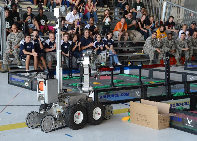 Competitors and spectators watch as a F6A EOD robot performs by picking up and dropping a ping-pong ball during a break in the Delaware State VEX Championship Oct. 6, 2012, at Hangar 706 on Dover Air Force Base, Del. One of the reasons the Air Force and Team Dover hosted the competition was to expose competitors to the technology and careers the Air Force has to offer. (U.S. Air Force photo by Tech. Sgt. Chuck Walker)