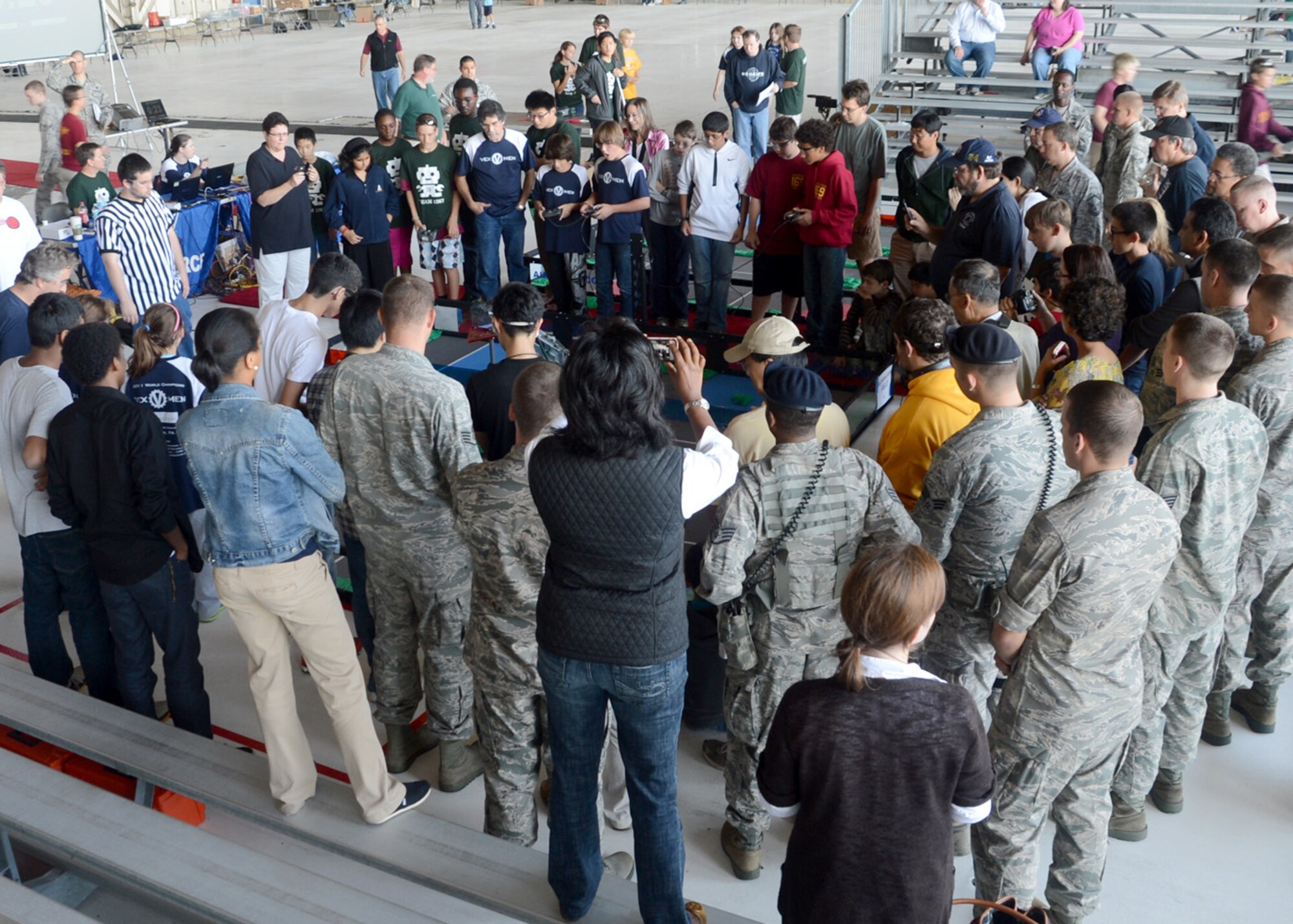Spectators and competitiors crowd around one of the competition fields to watch the robots compete during the Delaware State VEX Championship Oct. 6, 2012, at Hangar 706 on Dover Air Force Base, Del. 37 teams from Delaware, Pennsylvania, New Jersey and Maryland competed in the robotics competition. (U.S. Air Force photo by Tech. Sgt. Chuck Walker)