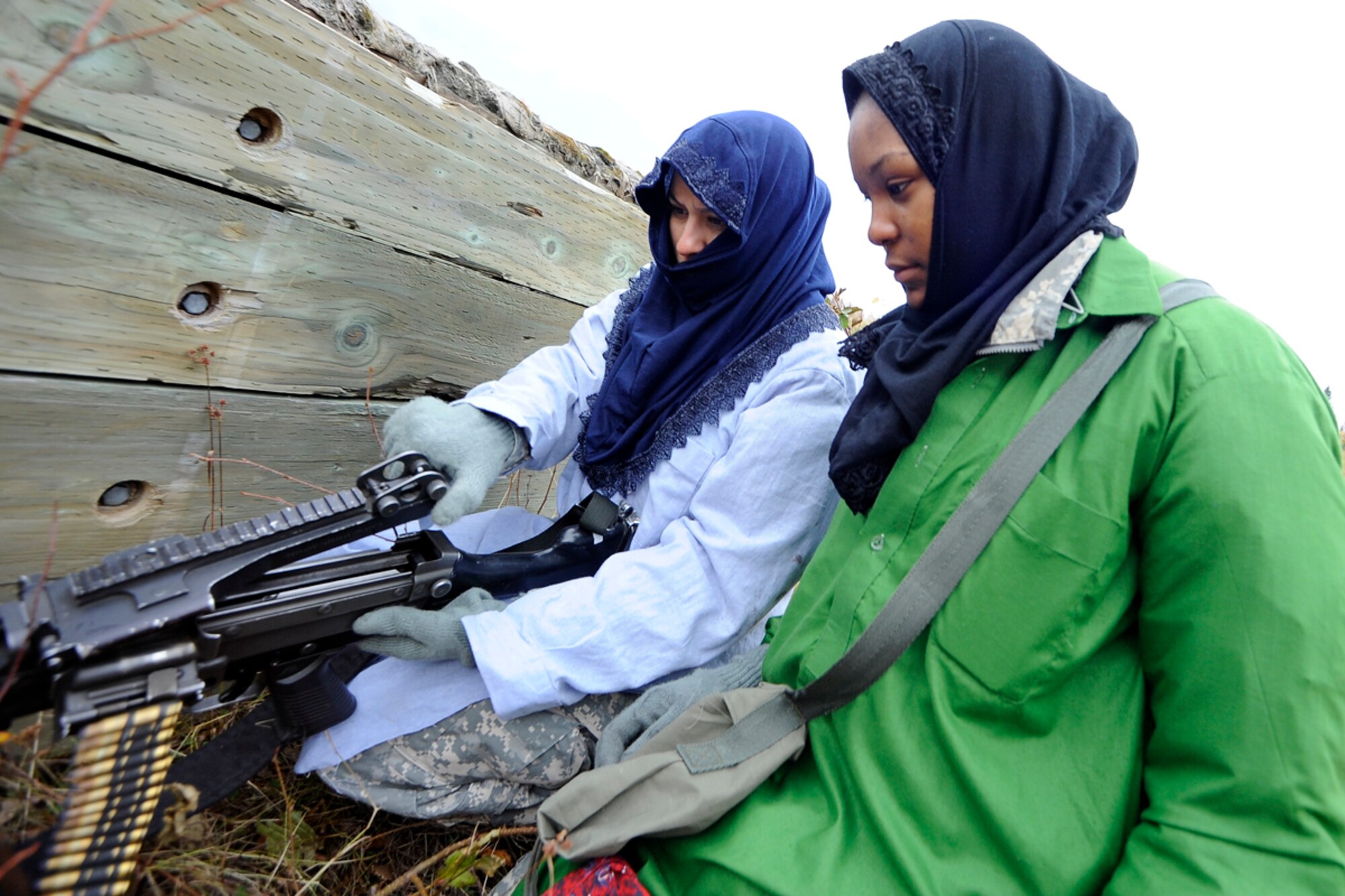 JOINT BASE ELMENDORF-RICHARDSON, Alaska ? "Insurgents" prepare their weapon to attack a convoy as Soldiers from the 95th Chemical Company, 6th Engineer Battalion, conduct battle drills at the Infantry Squad Battle Course, JBER-Richardson, September 25, 2012.  The small unit?s ability to accomplish its mission often depends on the Soldiers? ability to execute key actions quickly with minimal leader commands.  During the exercise, Soldiers were exposed to various scenarios requiring them to react to contact, react to ambush, react to and report improvised explosive devices, and interact with local indigenous personnel, to include key leader engagements.  (U.S. Air Force photo/Percy G. Jones)