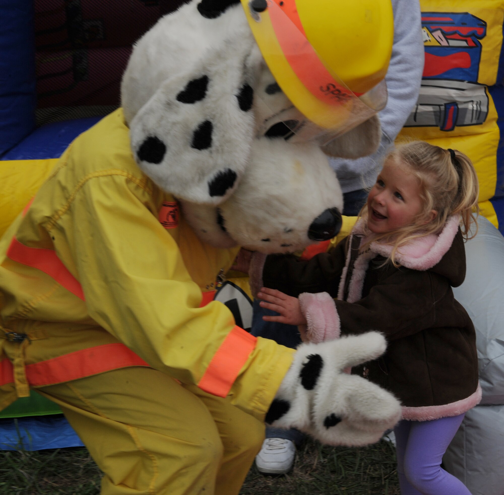 WHITEMAN AIR FORCE BASE, Mo. -- Sparky the Fire Dog gives a child a hug during the Fire Prevention Week festivities, Oct. 6. The 509th Civil Engineer fire department also celebrated the week with a parade through base housing. (U.S. Air Force photo/Airman 1st Class Bryan Crane) (Released)