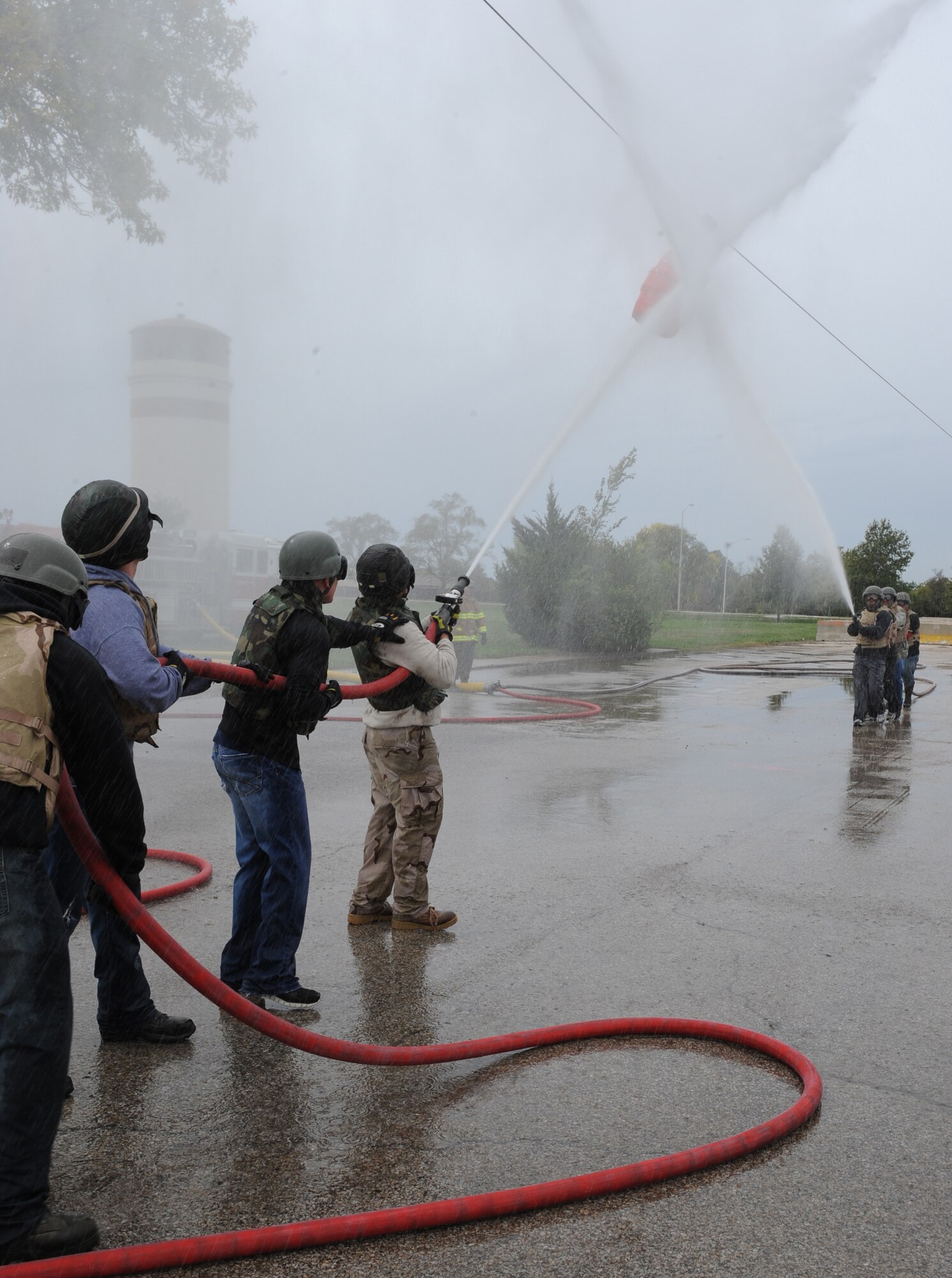 WHITEMAN AIR FORCE BASE, Mo. --The Fire Department Fire Muster team faces off against the MUNS Fire Muster team in a water shoot barrel contest, Oct. 6. The Fire Muster challenge featured three events. The Wolfpack Fire Muster team won the water shoot barrel contest and the overall Fire Muster. (U.S. Air Force photo/Airman 1st Class Bryan Crane) (Released)