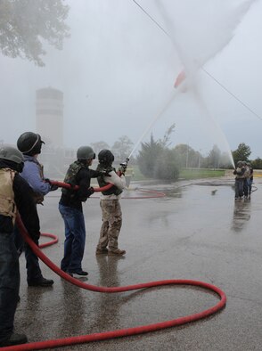 WHITEMAN AIR FORCE BASE, Mo. --The Fire Department Fire Muster team faces off against the MUNS Fire Muster team in a water shoot barrel contest, Oct. 6. The Fire Muster challenge featured three events. The Wolfpack Fire Muster team won the water shoot barrel contest and the overall Fire Muster. (U.S. Air Force photo/Airman 1st Class Bryan Crane) (Released)