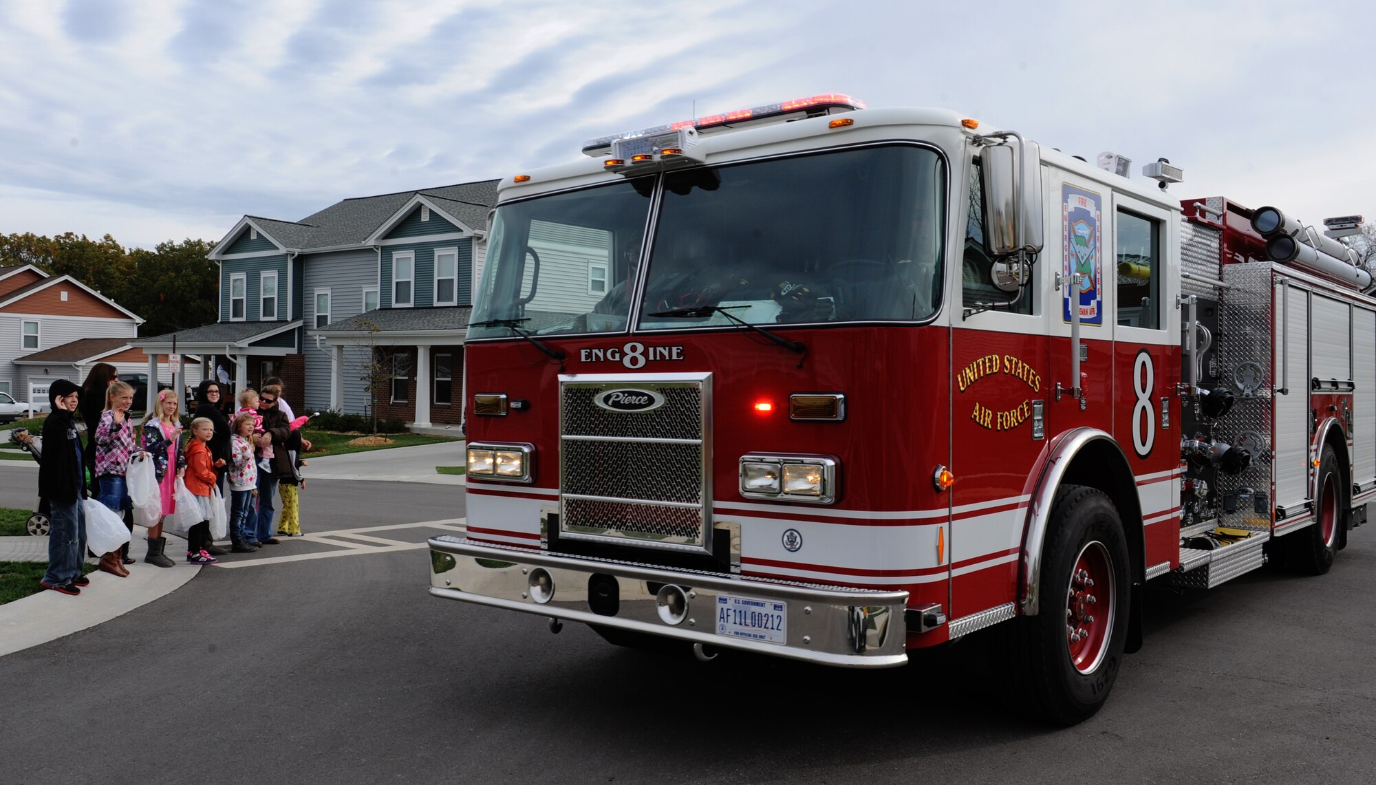 WHITEMAN AIR FORCE BASE, Mo. -- The 509th Civil Engineer Fire Department’s Engine #8 drives through base housing during the Fire Prevention Week parade, Oct. 6. The 509th Civil Engineer Fire Department also held activities for kids and a Fire Muster Challenge. (U.S. Air Force photo/Airman 1st Class Bryan Crane) (Released)