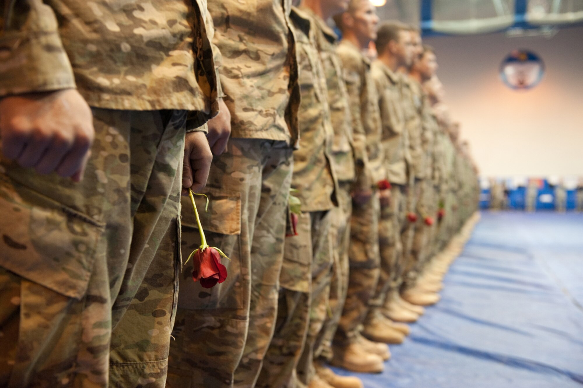 Many of the nearly 300 members of the 4th Brigade Combat Team (Airborne), 25th Infantry Division hold flowers for their loved ones while waiting to be released to their families at the Buckner Physical Fitness Center on JBER Sept. 27. The troops returned home on the first main body flight after a 10-month deployment in support of Operation Enduring Freedom.  (U.S. Air Force photo/Staff Sgt. Robert Barnett)