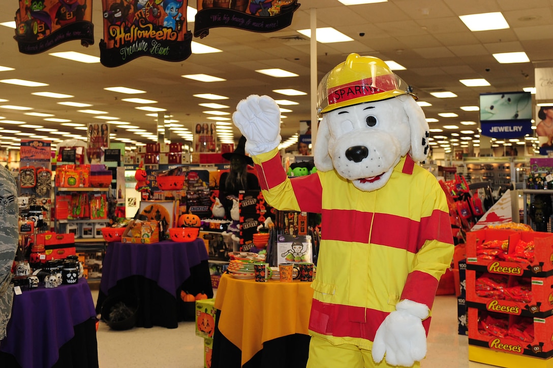 Sparky the Fire Dog winks at customers entering the Base Exchange during a Fire Prevention Week demonstration at Langley Air Force Base, Va., Oct. 9, 2012. The 633rd Civil Engineer Squadron fire department hosts the annual event to inform personnel and their dependents about the importance of fire safety. (U.S. Air Force photo by Staff Sgt. Ashley Hawkins/Released)
