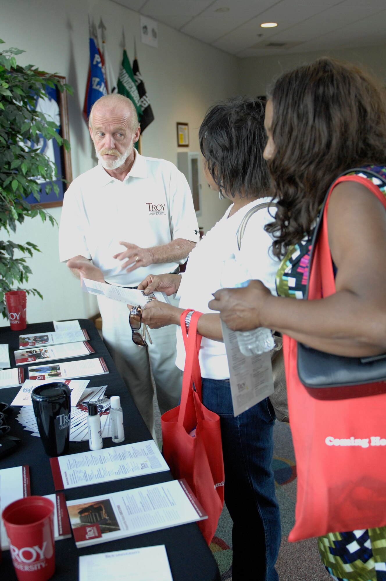 James Egan, Troy University's assistant director of student services at the Sumter campus, informs visitors of educational opportunities during an education fair at Shaw Air Force Base, S.C., Oct. 2, 2012. There were nine other schools that also set up booths at the fair along with the Department of Veterans Affairs, Troops to Teachers and the Fort Jackson Education Center. (U.S. Air Force photo by Airman 1st Class Krystal M. Jeffers/Released)

