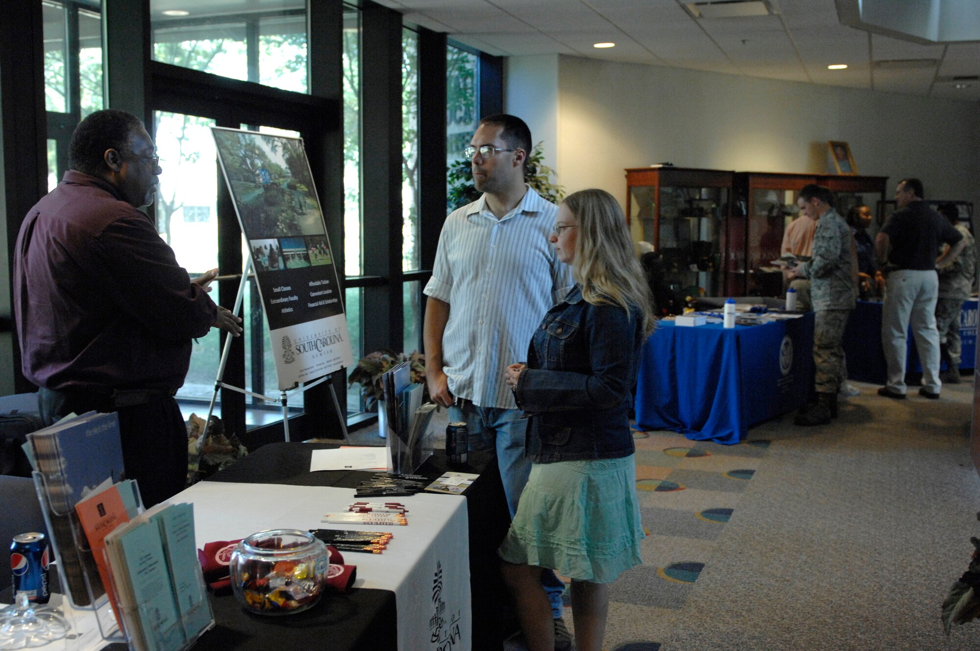 Staff Sgt. Jackie Sevdy, U.S. Air Forces Central air threat analyst, and her husband, Staff Sgt. Coby, U.S. Air Forces Central Network, Operation and Security Center enterprise controller, speak to Ricky Boyd, the director of the Shaw Program at the University of South Carolina Sumter, during an education fair at Shaw Air Force Base, S.C., Oct. 2, 2012. The education center invited 10 colleges; the five on-base colleges and the five most popular off-base colleges with Team Shaw, according to Don Ellwood, 20th Force Support Squadron chief of education and training. (U.S. Air Force photo by Airman 1st Class Krystal M. Jeffers/Released)

