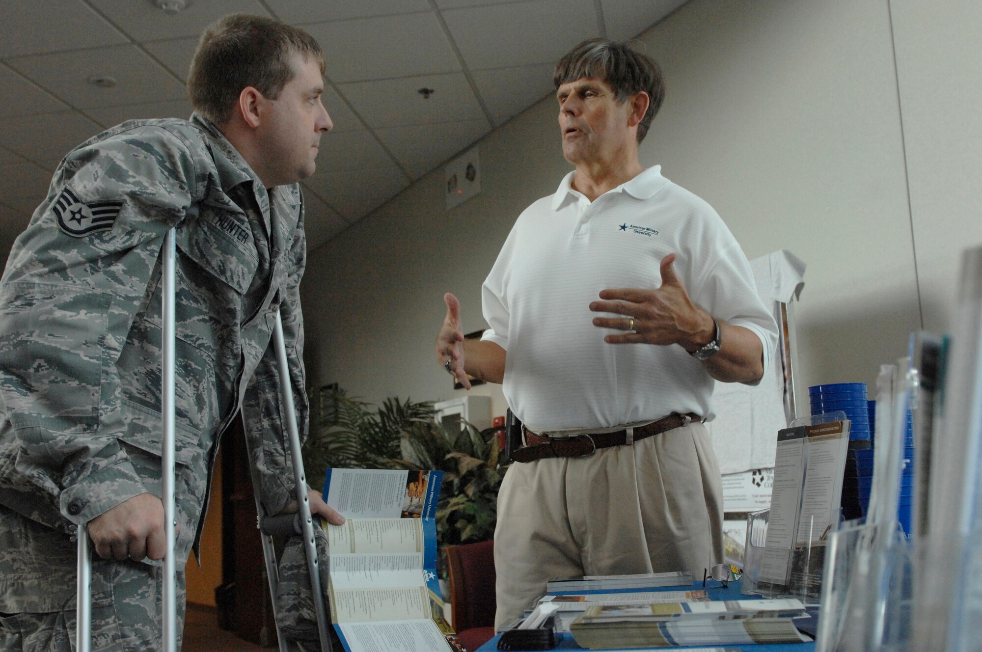 Staff Sgt. Robert Hunter, 20th Contracting Squadron contracting specialist, questions Floyd Maertens, American Military University's education coordinator, about education opportunities for military members during an education fair at Shaw Air Force Base, S.C., Oct. 2, 2012. According to Don Ellwood, 20th Force Support Squadron chief of education and training, the purpose of the event was to inspire Team Shaw to enroll in college and make college seem desirable. (U.S. Air Force photo by Airman 1st Class Krystal M. Jeffers/Released)

