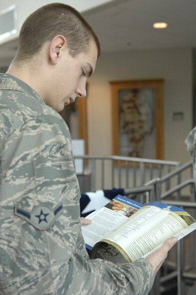 Airman Stephen Sullivan, 20th Contracting Squadron contracting specialist, reads a pamphlet from American Military University during an education fair at Shaw Air Force Base, S.C., Oct. 2, 2012. The fair was four hours long, and 10 colleges, the Department of Veterans Affairs, Troops to Teachers and the Fort Jackson Education Center participated in the event. (U.S. Air Force photo by Airman 1st Class Krystal M. Jeffers/Released)

