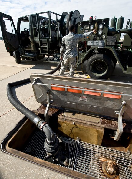 Senior Airman Matthew Henson, 2nd Logistics Readiness Squadron Fuels Flight, checks the gauges on an R-12 hydrant truck before removing the fuel from a B-52H Stratofortress on Barksdale Air Force Base, La., Oct. 9. The hydrant truck acts as a portable pump, moving fuel between the aircraft and the fuel storage tanks below the flightline, filtering it during the process. (U.S. Air Force photo/Staff Sgt. Chad Warren)(RELEASED)