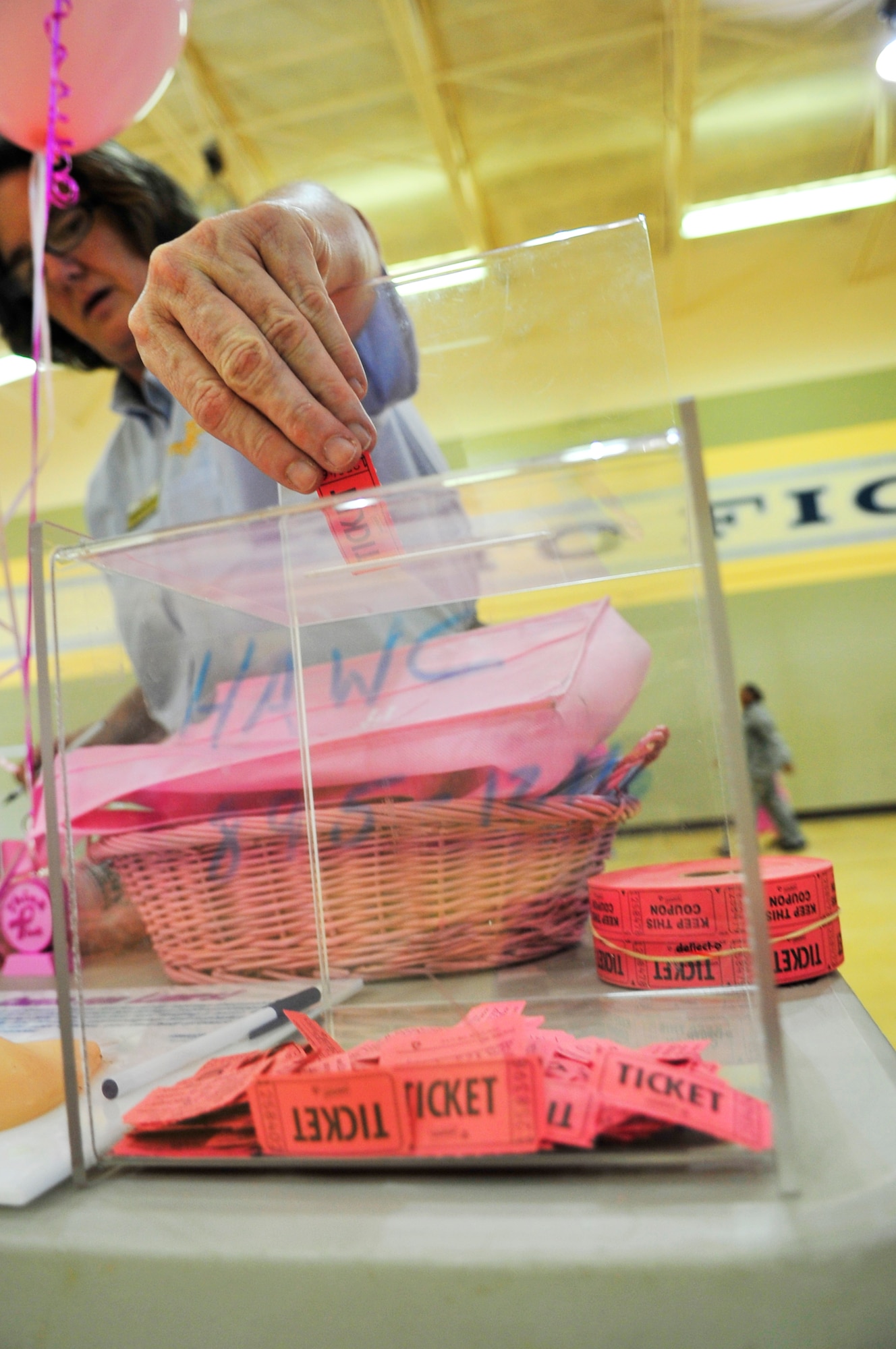 Valerie Burnier, Carolina Pines Inn housekeeping managers enters a raffle during the breast cancer awareness walk at the fitness center, Shaw Air Force Base, S.C., Oct. 2, 2012.  The event was held by the Health and Wellness Center along with the 20th Medical Group.  More than 100 people participated in the walk. (U.S. Air Force photo by Airman Nicole Sikorski/Released)