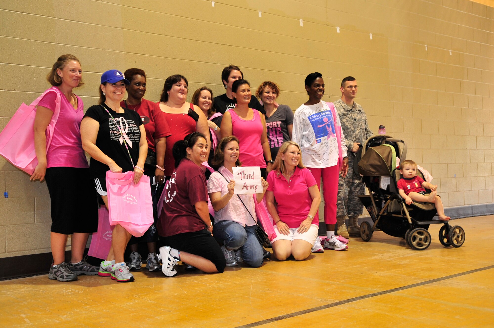 U.S. Army Soldiers and families gather for a group photo during the annual breast cancer awareness walk at the fitness center, Shaw Air Force Base, S.C., Oct. 2, 2012.  The event was held by the Health and Wellness Center along with the 20th Medical Group.  More than 100 people participated in the walk. (U.S. Air Force photo by Airman Nicole Sikorski/Released)