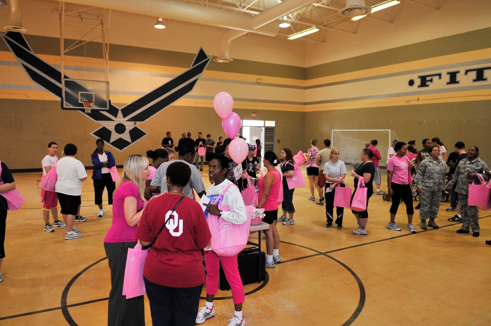 U.S. Air Force Airmen gather for the annual breast cancer awareness walk in the gymnasium at the fitness center, Shaw Air Force Base, S.C., Oct. 2, 2012.  The event was held by the Health and Wellness Center along with the 20th Medical Group.  More than 100 people participated in the walk. (U.S. Air Force photo by Airman Nicole Sikorski/Released)