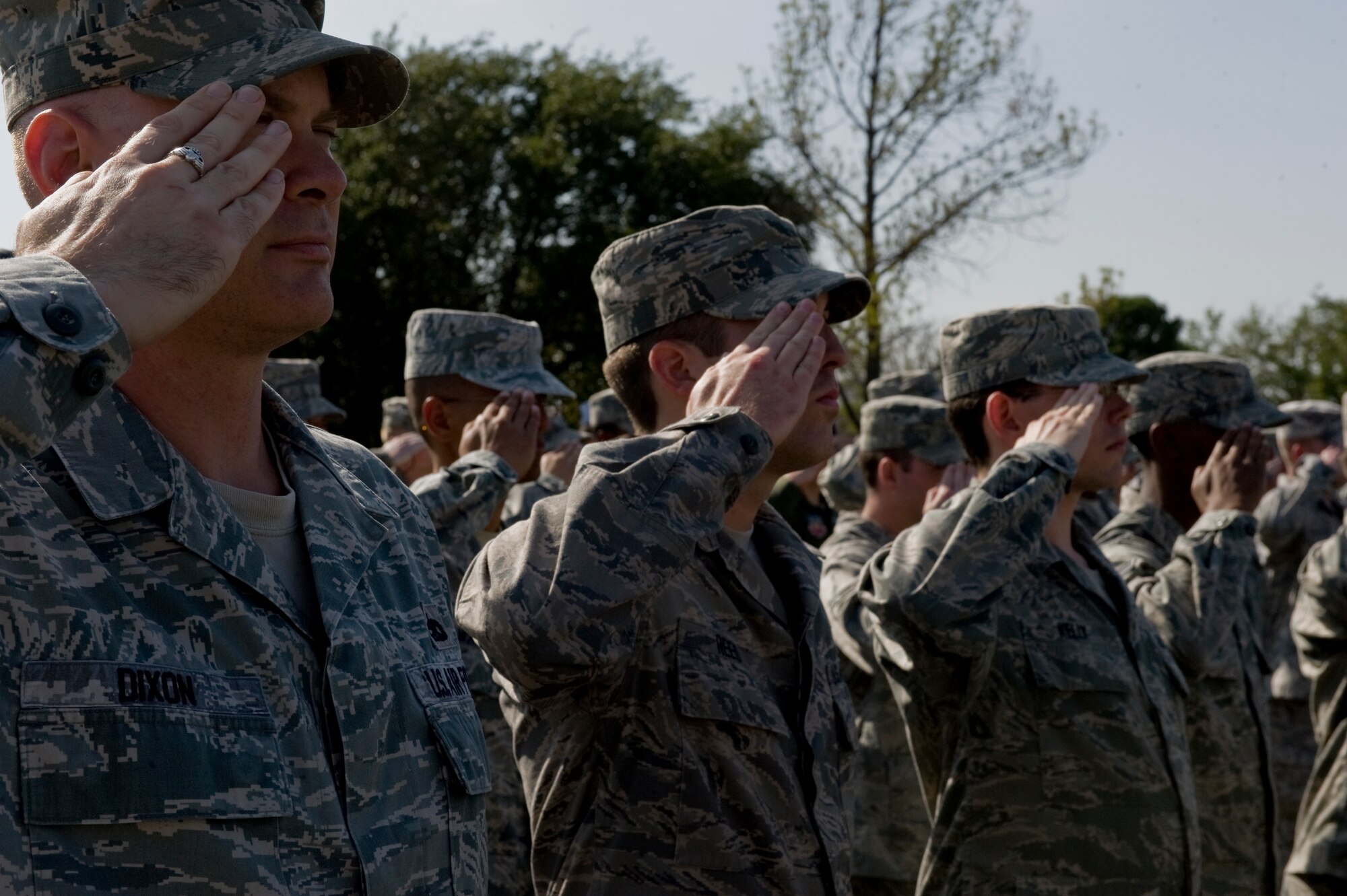 Airmen from the 7th Bomb Wing render a salute as the American flag is retrieved during a wing retreat ceremony Oct. 5, 2012, at Dyess Air Force Base, Texas. A retreat ceremony signifies the end of a duty day and is also a way to pay tribute to the American flag. (U.S. Air Force photo by Airman 1st Class Jonathan Stefanko/ Released)