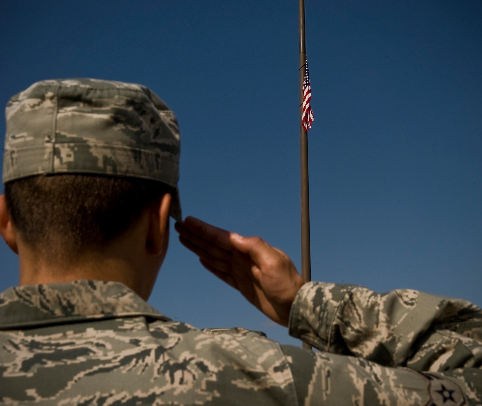 An Airman from the 7th Bomb Wing renders a salute as the American flag is retrieved during a wing retreat ceremony Oct. 5, 2012, at Dyess Air Force Base, Texas. A retreat ceremony signifies the end of a duty day and is also a way to pay tribute to the American flag. (U.S. Air Force photo by Airman 1st Class Jonathan Stefanko/ Released)