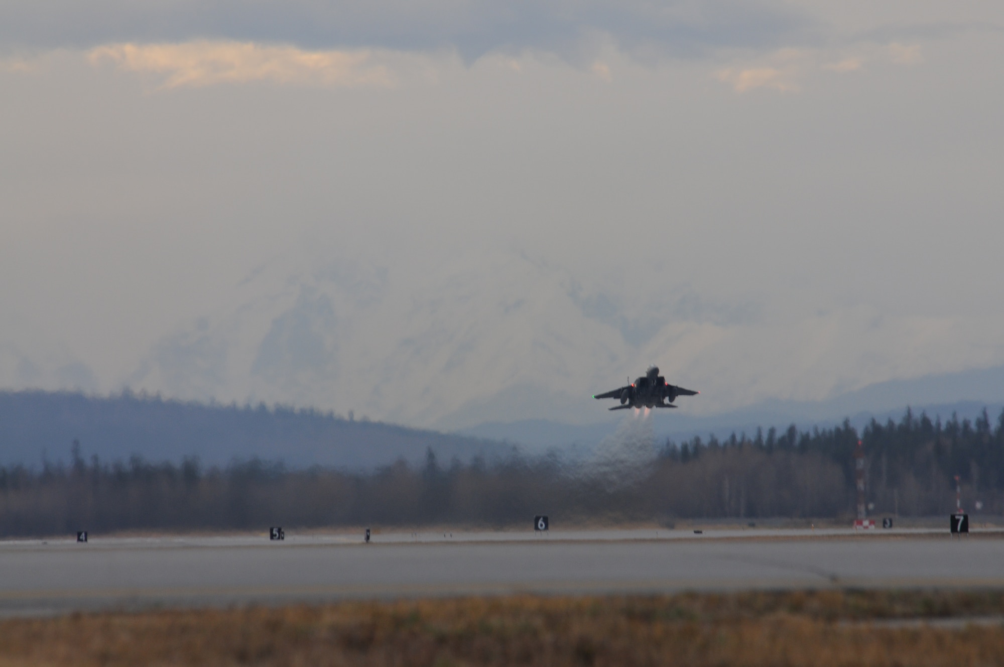 An F-15SG takes off during the early morning hours at Eielson Air Force Base, Alaska, Oct. 5, 2012. The aircraft is assigned to the 428th Fighter Squadron from Mountain Home Air Force Base, Idaho, and here to participate in RED FLAG-Alaska 13-1. (U. S. Air Force photo/Senior Airman Benjamin Sutton)  