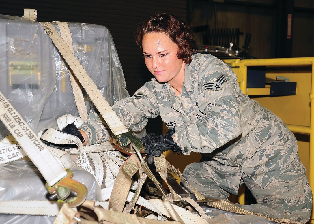WRIGHT-PATTERSON AIR FORCE BASE, Ohio - Senior Airman Maura Phillips, 87th Aerial Port Squadron cargo specialist/training manager for cargo, tightens the nets to a pallet to prevent cargo from shifting in flight during the Sept. 9 unit training assembly. (U.S. Air Force photo/Maj. Jose Cardenas)