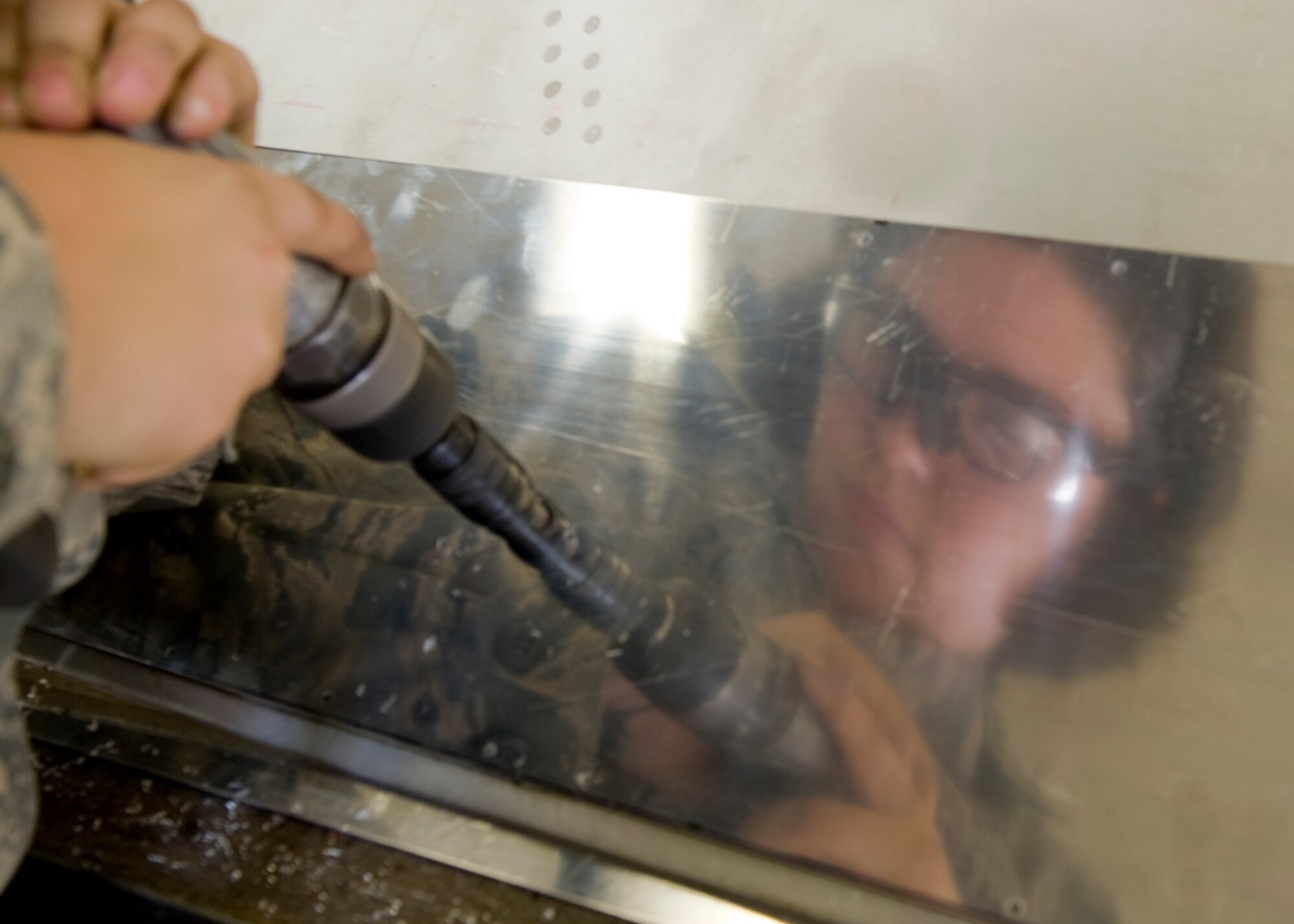 Airman 1st Class Brittany Czekalski, 7th Equipment Maintenance Squadron, works on a piece of sheet metal during the restoration of an RB-66 Oct. 4, 2012, at Dyess Air Force Base, Texas. Once restored, the RB-66 will be displayed in the Dyess Linear Airpark. (U.S. Air Force photo by Airman 1st Class Peter Thompson/ Released)