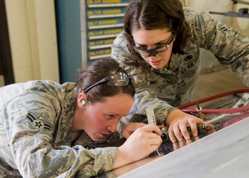 Airman 1st Class Hailey Kahrs, left, and Airman 1st Class Brittany Czekalski, 7th Equipment Maintenance Squadron, use a grip length gauge to measure the length of a required rivet during the restoration of an RB-66 Oct. 4, 2012, at Dyess Air Force Base, Texas. Once restored, the RB-66 will be displayed in the Dyess Linear Airpark. (U.S. Air Force photo by Airman 1st Class Peter Thompson/ Released)