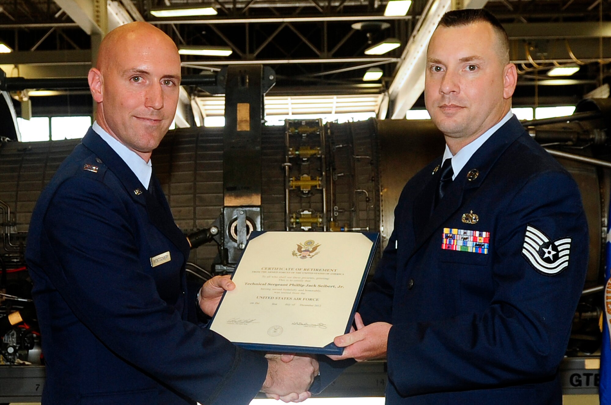 U.S. Air Force Capt. Robert Montgomery, 20th Component Maintenance Squadron accessories flight commander, presents Tech. Sgt. Phillip Seibert, 20th CMS material support assistant section chief, with his certificate of retirement at Shaw Air Force Base, S.C., Oct. 5, 2012. Seibert served 22 years of active-duty military service. (U.S. Air Force photo by Airman Hunter Brady/Released)
