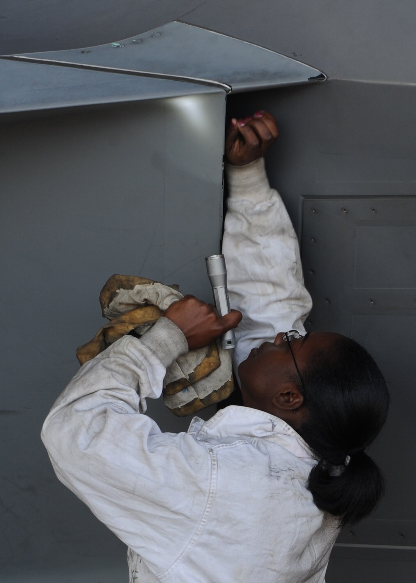 U.S. Air Force Senior Airman Kimara Duncan, 94th Aircraft Maintenance Unit tactile aircraft maintainer, inspects an F-22 Raptor for visible damage during routine maintenance on an F-22 Raptor at Langley Air Force Base, Va., Sept. 25, 2012. Duncan is dedicated crew chief of the 1st Fighter Wing flagship. While this position is often reserved for noncommissioned officers, Duncan has distinguished herself as an outstanding Airman. (U.S. Air Force photo by Senior Airman Racheal Watson/Released)