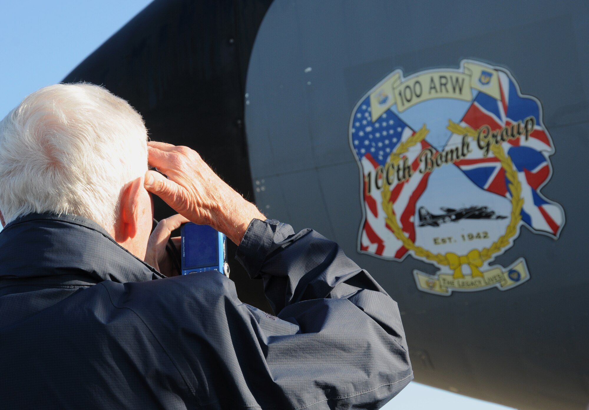 A member of the Friends of the Imperial War Museum Duxford takes a photo of the nose art on a KC-135 Stratotanker aircraft during a base tour Oct. 9, 2012, at RAF Mildenhall, England. The tour was conducted by members of the 100th OSS for the friends of the museum as well as for Adam Kendall, the 100th OSS honorary commander, and went to several 100th OSS areas of operation. (U.S. Air Force photo by Tech. Sgt. Neal X. Joiner/Released) 