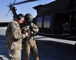 U.S. Army Sgt. Jerimia Fritcher, left, 622nd Movement Control Detachment air operations noncommissioned officer, talks with a helicopter loadmaster while writing down weights for a load plan Oct. 4, 2012, at Forward Operating Base Shank, Afghanistan. The 622nd MCT has completed more than 3,700 ground and air missions during its deployment from Fort Eustis, Va. (U.S. Army photo by Sgt. Gregory Williams / Released)