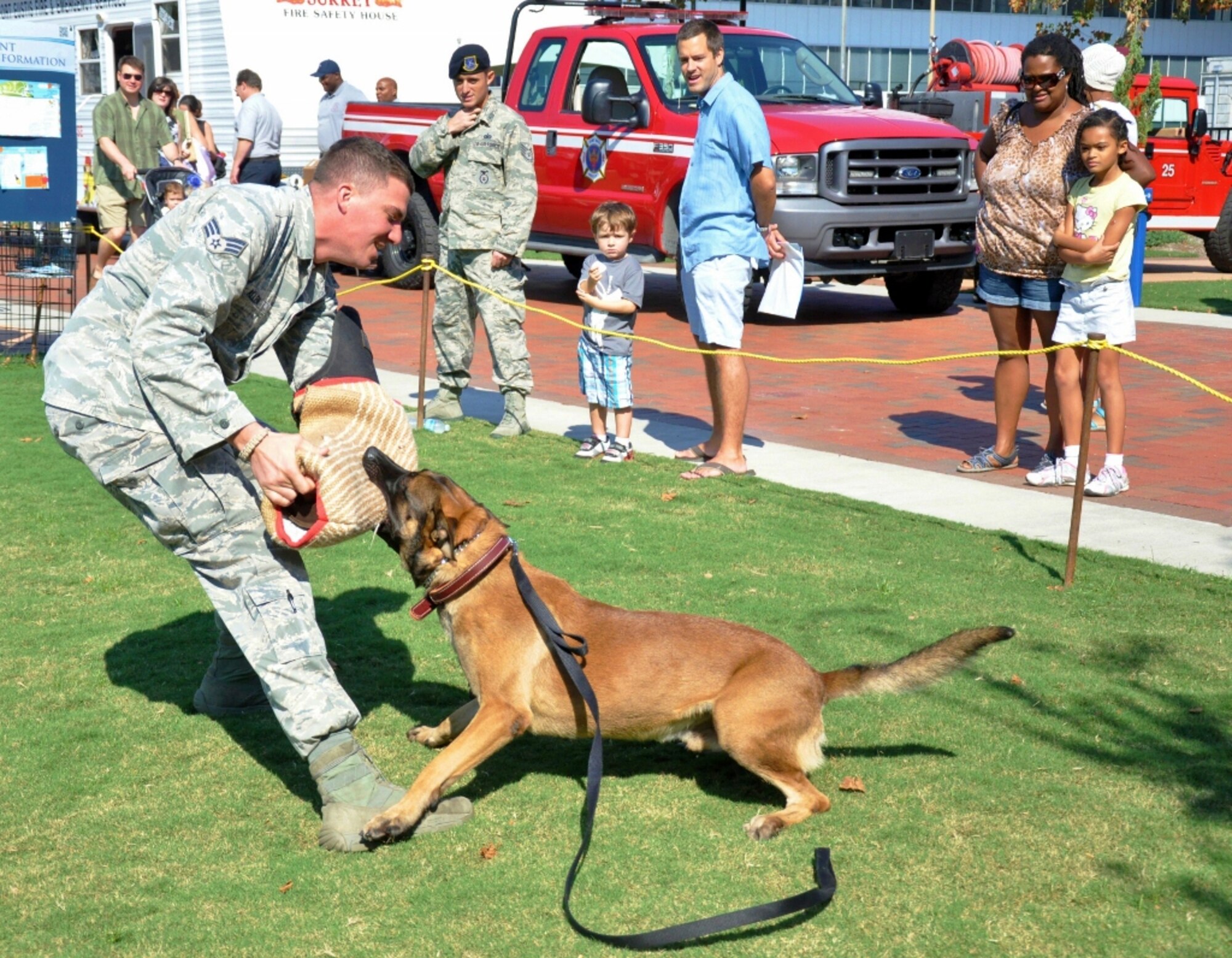 U.S. Air Force Senior Airman Jeremy Allen, 633rd Security Forces Squadron military working dog handler, plays suspect for his MWD to apprehend during a demonstration at the Norfolk Children's Festival at Town Point Park in downtown Norfolk, Va., Oct. 6, 2012. The Airmen visited the festival to entertain and educate the public about the important mission of MWDs and handlers. (U.S. Air Force photo by Senior Airman Jason J. Brown/Released)