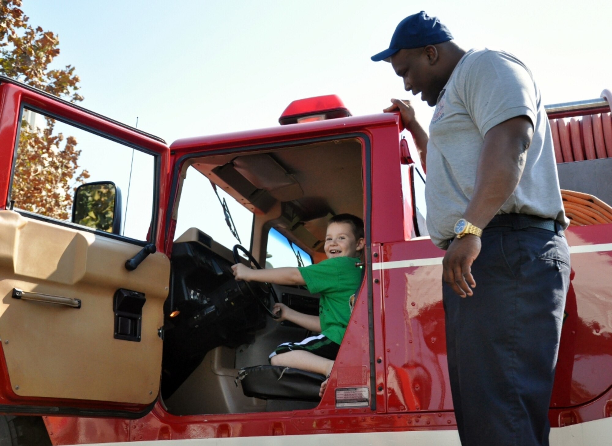 Keith Boyd, a Fort Eustis Fire Department fire inspector, lets 6-year-old Riley Fesser take the wheel of the department's specialized “brush truck” at the Norfolk Children's Festival at Town Point Park in downtown Norfolk, Va., Oct. 6, 2012. Personnel from the FEFD and the 633rd Security Forces Squadron brought unique capabilities to the festival to entertain and educate guests about their respective missions. (U.S. Air Force photo by Senior Airman Jason J. Brown/Released)