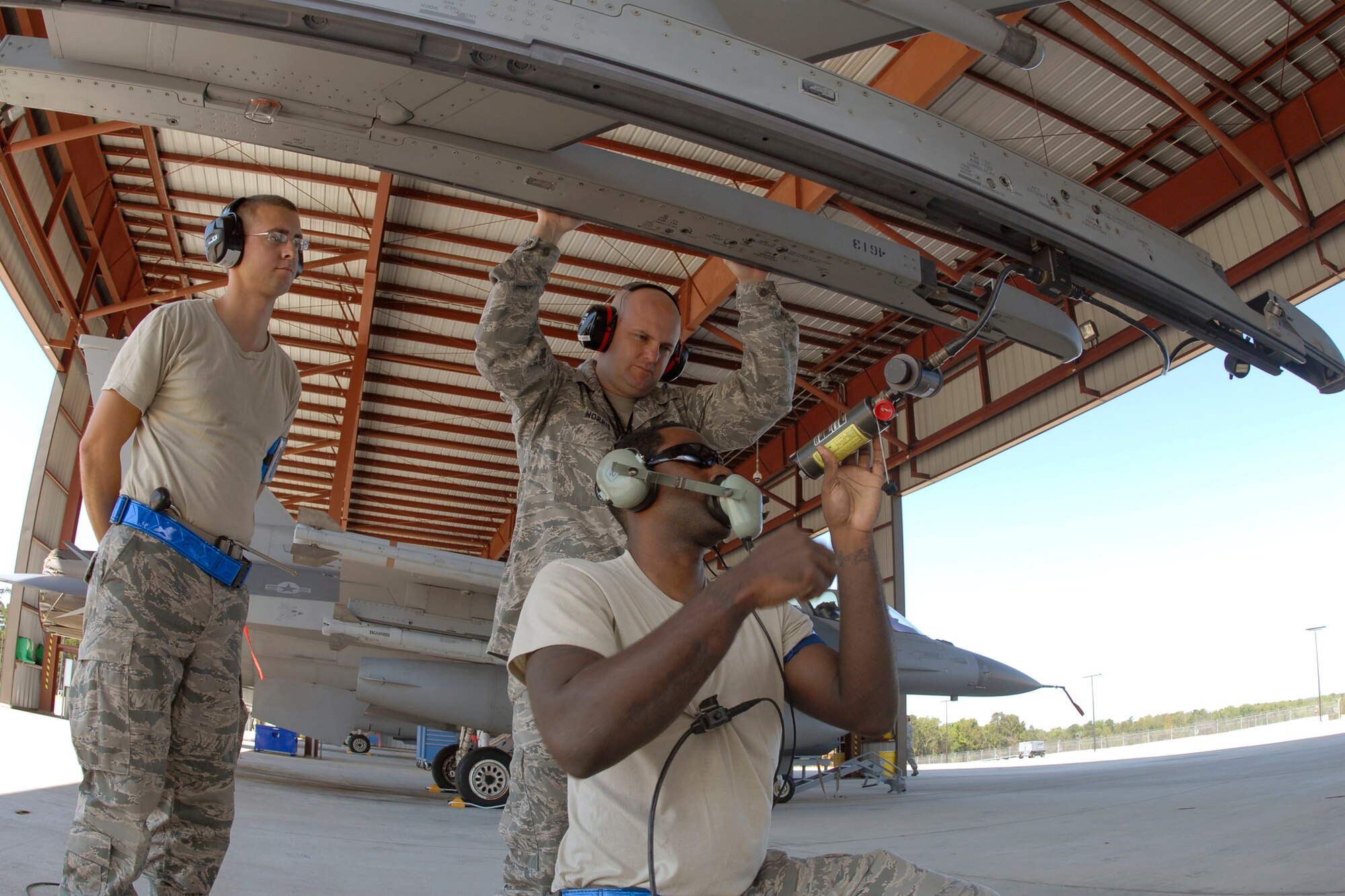 Senior Master Sgt. Brian Norris, a weapons inspector assigned to AFNORTH/1AF from Tyndall Air Force Base, Fla., evaluates a 169th Fighter Wing's weapons load team during a weapons reliability check, Sept. 26, 2012. The McEntire team consists of Master Sgt. Jeremy Pow, team leader, and Senior Airmen Steven Hollis (left) and Carlos Graham (center), all assigned to the 169th Fighter Wing's Aerospace Control Alert unit.  McEntire Joint National Guard Base's Aerospace Control Alert mission receives an Alert Force Operational Assessment (AFOA) inspection from 1AF/AFNORTH to evaluate its ability to provide for our nation's homeland defense. McEntire is home of the Swamp Foxes of the South Carolina Air National Guard and the 169th Fighter Wing.