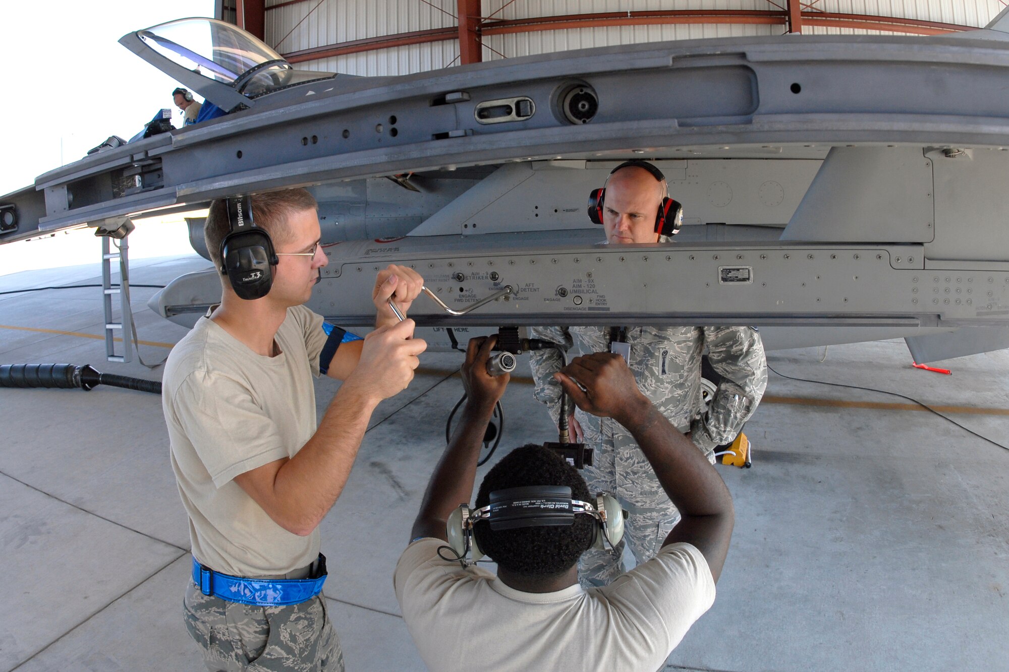 Senior Master Sgt. Brian Norris, a weapons inspector assigned to AFNORTH/1AF from Tyndall Air Force Base, Fla., evaluates a 169th Fighter Wing's weapons load team during a weapons reliability check, Sept. 26, 2012. The McEntire team consists of Master Sgt. Jeremy Pow, team leader, and Senior Airmen Steven Hollis (left) and Carlos Graham (foreground center), all assigned to the 169th Fighter Wing's Aerospace Control Alert unit. McEntire Joint National Guard Base's Aerospace Control Alert mission receives an Alert Force Operational Assessment (AFOA) inspection from 1AF/AFNORTH to evaluate its ability to provide for our nation's homeland defense. McEntire is home of the Swamp Foxes of the South Carolina Air National Guard and the 169th Fighter Wing.