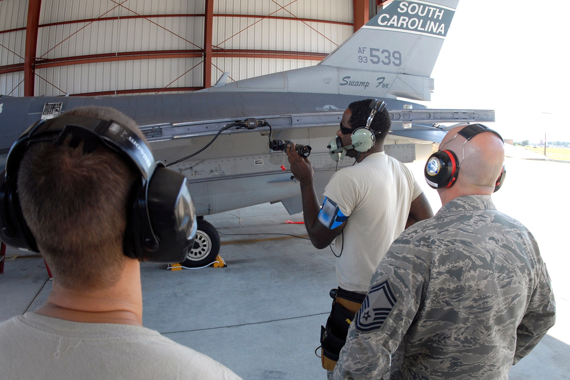 Senior Master Sgt. Brian Norris, a weapons inspector assigned to AFNORTH/1AF from Tyndall Air Force Base, Fla., evaluates a 169th Fighter Wing's weapons load team during a weapons reliability check, Sept. 26, 2012.  The McEntire team consists of Master Sgt. Jeremy Pow, team leader, and Senior Airmen Steven Hollis (left) and Carlos Graham (center), all assigned to the 169th Fighter Wing's Aerospace Control Alert unit.  McEntire Joint National Guard Base's Aerospace Control Alert mission receives an Alert Force Operational Assessment (AFOA) inspection from 1AF/AFNORTH to evaluate its ability to provide for our nation's homeland defense.  McEntire is home of the Swamp Foxes of the South Carolina Air National Guard and the 169th Fighter Wing.