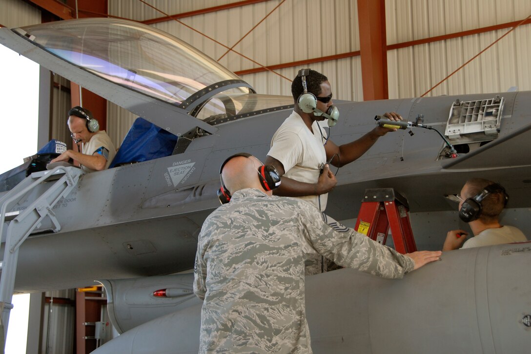 Senior Master Sgt. Brian Norris, a weapons inspector assigned to AFNORTH/1AF from Tyndall Air Force Base, Fla., evaluates a 169th Fighter Wing's weapons load team during a weapons reliability check, Sept. 26, 2012.  The McEntire team consists of Master Sgt. Jeremy Pow, team leader, and Senior Airmen Steven Hollis and Carlos Graham, all assigned to the 169th Fighter Wing's Aerospace Control Alert unit.  McEntire Joint National Guard Base's Aerospace Control Alert mission receives an Alert Force Operational Assessment (AFOA) inspection from 1AF/AFNORTH to evaluate its ability to provide for our nation's homeland defense.  McEntire is home of the Swamp Foxes of the South Carolina Air National Guard and the 169th Fighter Wing.