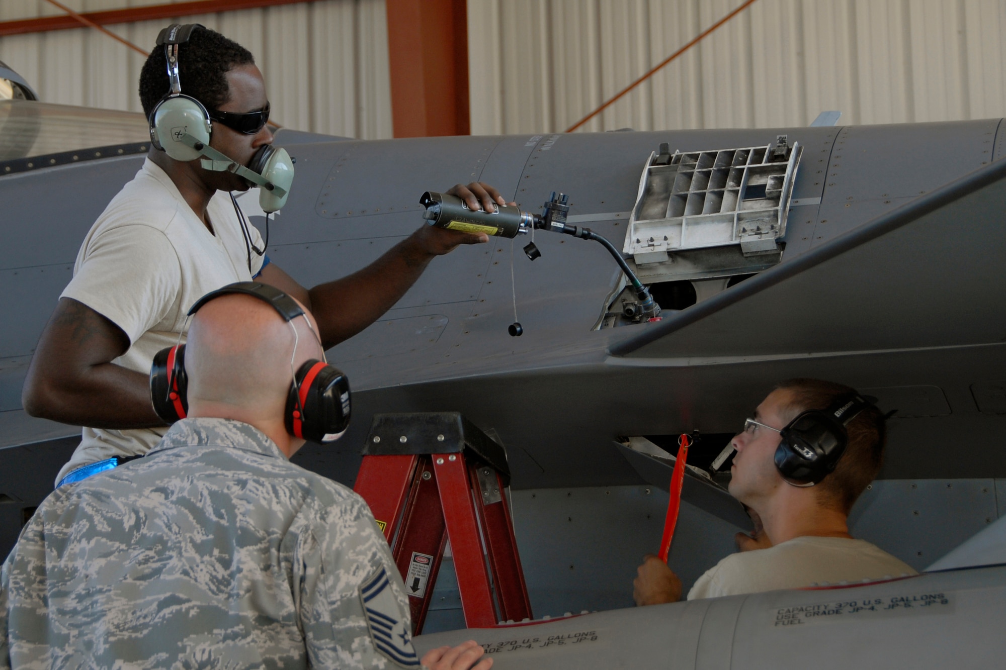 Senior Master Sgt. Brian Norris, a weapons inspector assigned to AFNORTH/1AF from Tyndall Air Force Base, Fla., evaluates a 169th Fighter Wing's weapons load team during a weapons reliability check, Sept. 26, 2012. The McEntire team consists of Master Sgt. Jeremy Pow, team leader, and Senior Airmen Steven Hollis (right) and Carlos Graham (upper-left), all assigned to the 169th Fighter Wing's Aerospace Control Alert unit. McEntire Joint National Guard Base's Aerospace Control Alert mission receives an Alert Force Operational Assessment  inspection from 1st AF/AFNORTH to evaluate its ability to provide for our nation's homeland defense.  McEntire is home of the Swamp Foxes of the South Carolina Air National Guard and the 169th Fighter Wing.